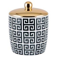 a black and white container with gold accents on the lid, sitting in front of a white background