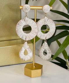 Our Moon River Raffia Wrapped Circle And Teardrop Earrings are a beautiful and unique accessory that will add a touch of bohemian style to any outfit. These earrings feature a stunning combination of circular and teardrop shapes wrapped in ivory raffia, creating a textured and interesting look.
Expertly crafted with attention to detail, these earrings feature post backs that provide a secure and comfortable fit. At 4.25 inches long, they dangle gracefully from your ears, adding movement and dime Summer Beach Teardrop Earrings, Bohemian White Tassel Earrings For Pierced Ears, White Bohemian Teardrop Earrings For Pierced Ears, White Bohemian Teardrop Earrings, Bohemian Dangle Teardrop Earrings For The Beach, Bohemian Teardrop Earrings For Vacation, White Teardrop Earrings, Handmade Bohemian Teardrop Earrings For Beach, Bohemian Handmade Teardrop Earrings For Beach