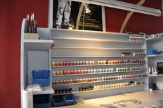 a store with shelves filled with different types of paint and other items on the counter