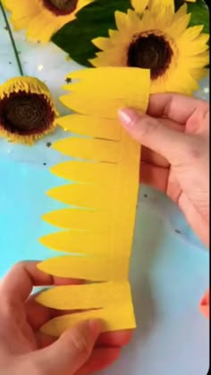 someone is making sunflowers out of construction paper