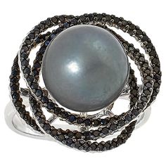 Kwan Collections Sterling Silver Tahitian Pearl and Black Spinel Ring  A shimmering black Tahitian pearl paired with the diamond-like sparkle of black spinel and fashioned into a beautiful, modern ring design, makes an elegant addition to any accessories collection.       Approx. 3/4"L x 13/16"W x 9/16"H; shank 1/16"W     Stamped .925; rhodium plating     Sterling silver ring has 11-12mm off-round black pearl at center of open frame comprised of overlapping hoops     Frame lined with round, blac Elegant Black Pearl Ring For Gift, Anniversary Black Tahitian Pearl Ring, Elegant Black Multi-stone Jewelry, Black Multi-stone Round Rings, Elegant Black Rings With Gemstone Accents, Formal Black Tahitian Pearl Ring, Black Tahitian Pearl Ring, Black Multi-stone Fine Jewelry, Fine Jewelry With Black Multi-stone