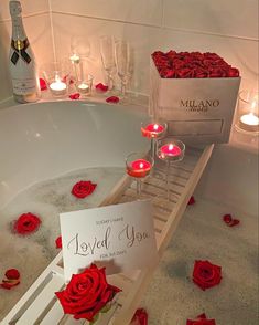 candles and roses in a bathtub with a card saying loved you next to it