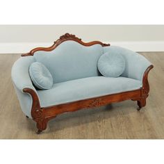 a blue couch sitting on top of a hard wood floor