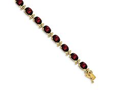 14k yellow gold 16 cttw garnet bracelet. Measures approximately 3/16 of an inch in width and has a box catch closure. Classic Gold Ruby Tennis Bracelet, Elegant Red Gold Bracelet For Formal Occasions, Formal Ruby Bracelets In Gold, Gold Ruby Bracelets For Formal Occasions, Formal Gold Bracelets With Ruby, Formal Yellow Gold Garnet Jewelry, Gold Oval Ruby Bracelets, Oval Ruby Bracelet In Gold, Oval Gold Ruby Bracelets