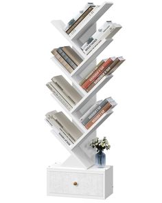 a tall white book shelf with books on it's sides and flowers in the middle