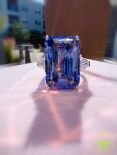 29 Carat Emerald Cut Three Stone ROYAL Blue SAPPHIRE Simulant Ring Fabulous Anniversary Engagement Ring S925/14K/18K The Mainstone size is 13*20mm (29 Carat) Made to order ♥925 SILVER WITH 18KGP ♥ The main stone is the finest Lab-Grown Sapphire  ♥Absolutely gorgeous and beautifully handcrafted Lab-Grown Sapphire Ring in solid 925 Sterling Silver. ♥ This classic yet trendy Ring makes the perfect Christmas/Anniversary/Valentine's/Birthday gift for her that will be treasured forever. We have confid Luxury Blue Emerald Ring For Wedding, Luxury Blue Emerald Wedding Ring, Blue Emerald Promise Ring In Fine Jewelry Style, Fine Jewelry Blue Emerald Promise Ring, Blue Emerald Ring With Accent Stones For Anniversary, Blue Tanzanite Emerald Cut Ring, Blue Gia Certified Emerald Ring For Formal Occasions, Exquisite Blue Sapphire Promise Ring, Formal Blue Emerald Ring With Accent Stones