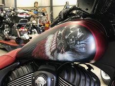 a motorcycle with a skull painted on the front and back tire cover is parked in a garage