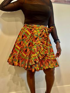 Relax in the beauty of African history with our stunning Kente wrap skirt. Crafted from the finest Kente fabric, this masterpiece has complex designs and brilliant colours that represent grandeur and prestige. Whether you like the classic beauty of a maxi, the whimsical appeal of a mini, or the elegant allure of a midi, our Kente wrap skirts are a tribute to African culture. The wrap design flatters every form, and the sumptuous Kente fabric drapes elegantly. Elevate your wardrobe with this striking item that flawlessly combines heritage and current design. Experience the beauty of Kente and create a striking fashion statement. Features:  ✨Kente fabric, wrap style, versatile length options, handcrafted details. ✨Perfect for Special occasions, cultural events, and evening wear. ✨Pair with a Fitted Multicolor Ruffled Mini Skirt, Multicolor Fitted Long Wrap Skirt, Traditional Fitted Multicolor Skirt, Fitted Multicolor Asymmetrical Skirt, Fitted Multicolor Tiered Wrap Skirt, Multicolor Relaxed Flared Wrap Skirt, Fitted Multicolor Tiered Skirt, Fitted Multicolor Ruffled Maxi Skirt, Bohemian Fitted Mini Skirt With Gathered Details