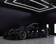 a black car is parked in the garage