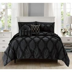 a black comforter set in a bedroom