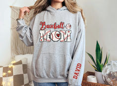 This customizable Baseball Mom hoodie comes in several colors and makes the perfect gift for mom! Casual Customizable Hoodie For Sports Events, Casual Personalized Hooded Hoodie, Cotton Hoodie With Letter Print For Sports Events, Casual Hoodie With Name Print, Casual Personalized Crew Neck Hoodie, Casual Crew Neck Hoodie With Personalization, Casual Crew Neck Hoodie With Personalized Details, Customizable Cotton Hoodie For Sports Events, Athletic Heather Hoodie With Letter Print For Sports