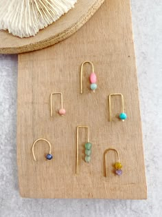 Summertime ahead! These are the earrings! They are light, fun and fun little pops of color! Mini open hoops with little gemstones! Your choice of: Mini arch hoops with vintage hot pink beads with aquamarine Mini hook hoops with aventurine Mini open hoops with sodalite (dark mar let blue) Staple hoops with pink coral Staple hoops with turquoise Mini arch hoops with yellow tigers eye and amethyst I have mini arch hoops also with hematite (black mirror gemstone) in a separate listing! I have bigger Yellow Tigers Eye, Mom Earrings, Handmade Wire Jewelry, Homemade Jewelry, Pink Beads, Pink Coral, Coral Turquoise, Tigers Eye, Beads And Wire