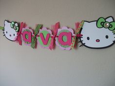 a hello kitty banner with the word dvor written in pink, green and white