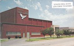 the building is red brick and has a white dove on it