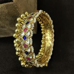 *This is 22k Gold Plated Kundan Bangle.(Single piece)Its perfect for Wedding Occasion as well as Gift and Bridal wear to match with Wedding Outfits. *Its made from Silver n Copper mix material and 100% Handmade. *Its Beaded with Gold Plated Balls Like shown in picture. *Its available in Various Sizes like 2,2.2,2.4,2.6,2.8 Etc. *Its openable Screwed Bangle Bracelet. *All Kundan stones set with silver foils handsetting method and long last guarantee of its workmanship.It is color combination of P Luxury Traditional Kundan Chandbalis, Luxury Kundan Bangle With Intricate Design, Heavy Cuff Bracelet For Festivals, Festive Multicolor Bracelets With Gota Work, Multicolor Cutdana Bracelets For Navratri, Multicolor Cutdana Bangle Bracelet, Multicolor Gota Work Bracelets For Festivals, Traditional Gold Bangle Bracelet Hand Set, Traditional Hand Set Gold Bangle Bracelet