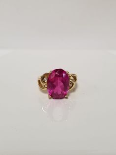 "Thanks for shopping our vintage estate store. We tend to sell well below wholesale and truly hope you enjoy all of our items. Many of the items are one of a kind, so please enjoy scrolling through the pictures and hopefully something will catch your eye. Spots are from reflections or camera. Estate 14k yellow gold created 6ct oval red ruby CZ .03ct Diamond cocktail filigree ring. No scratches on the gem. Stunning. Vintage setting, one that someone will love. Gem is testing natural, but it's created ruby. Size: 6 Setting: 1/2\" Band width: 2mm Weight:  4.89 grams Marked 14k. Gem is stunning." Collectible Oval 14k Gold Rings, Collectible 14k Gold Oval Rings, Oval 14k Gold Rings For Collectors, Classic Pink Ruby Ring For Formal Occasions, Formal Oval Ruby Ring With Center Stone, 14k Gold Oval Ruby Ring With Center Stone, Classic Oval Ruby Ring, 14k Stamped Oval Pink Jewelry, Pink Oval 14k Stamped Jewelry