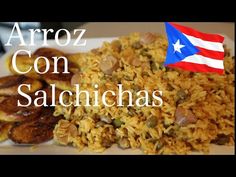 a white plate topped with rice, meat and other foods next to a puerto rican flag