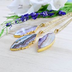 Stone: Amethyst Slice Chain Length: 16-30inch Dimensions: 1.5inches x 1inches (40mm x 25mm) Color: Gold Chain: Gold Stainless Steel Chain SKU: EPJ-N19SBA12 This necklace is made from a natural amethyst slice which has been cut into a marquise shape. The stone is plated with 24k gold on half of the edges and hangs from a gold stainless steel chain. Please choose the length you would like the necklace in. Please choose the chain style you would like your pendant on. All stones are natural. Any irr Purple Necklace With Large Round Pendant, Purple Necklace With Large Stone For Gift, Purple Spiritual Necklace With Large Pendant, Spiritual Purple Necklace With Large Pendant, Purple Pendant Necklace With Large Pendant, Purple Necklace With Large Pendant, Amethyst Necklace With Large Pendant For Healing, Amethyst Large Pendant Necklaces For Jewelry Making, Amethyst Large Pendant Jewelry Gift