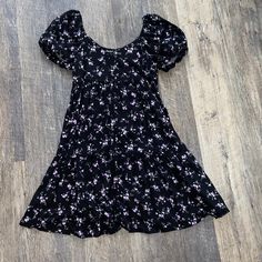 Black With Pretty Purple Flowers Brand New Has Tags... Nothing Is Wrong With It Xs But Fits Me Size Small If You Have A Bigger Chest, It May-Be A Little Tight Casual Purple Floral Dress For Summer, Cute Black Mini Dress With Short Sleeves, Flowy Black Floral Print Dress, Black Summer Dress With Ditsy Floral Print, Black Short Sleeve Dress With Ditsy Floral Print, Black Ditsy Floral Print Dress For Summer, Black Ditsy Floral Dress For Summer, Black Mini Dress With Ditsy Floral Print, Cute Purple Floral Print Mini Dress