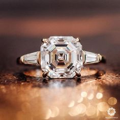 an old cut diamond ring sits on a table