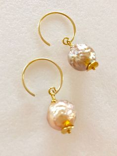 "Soft peach glow Chinese freshwater Kasumi pearls wire wrapped on handmade 24k gold vermeil ear wires Beautiful 11mm Chinese kasumi pearls with characteristic iridescent bumpy surface are full of color and texture and highly lustrous. They display a full array of metallic colors including dusty rose pink, peach and bronze. Stunning kasumi pearls are wire wrapped on 24k gold vermeil handmade ear wires with tiny gold vermeil wavy disc accents. Total length is 1 1/4\". Also in Sterling silver." Handmade Delicate Pearl Earrings, Handmade Pearl White Pearl Earrings, Artisan Jewelry With Pearl Drop For Gift, Wire Wrapped Round Pearl Jewelry, Handmade Dainty Pearl Earrings, Handmade Baroque Pearl Round Jewelry, Rose Gold Pearl Jewelry With Wire Wrapped Detail, Handmade Baroque Pearl Jewelry, Handmade Adjustable Pearl White Earrings