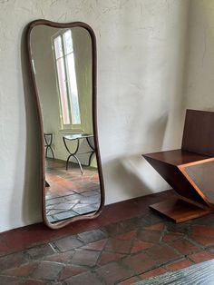 a large mirror sitting on top of a wooden table