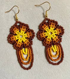 "Boho earrings measure 2\" long and 1.25\" wide." Long Drop Earrings With Ear Wire For Festival, Handmade Brown Beaded Earrings, Handmade Brown Earrings For Festival, Gift Brown Chandelier Earrings With Ear Wire, Traditional Brown Earrings For Festival, Yellow Festival Earrings With Matching Pair, Brown Long Drop Earrings For Gift, Nickel Free Brown Beaded Drop Earrings, Handmade Long Drop Yellow Jewelry