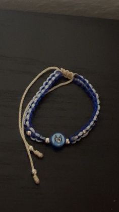 a blue and white bracelet with a button on it