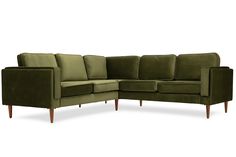 a green velvet sectional sofa with gold legs and arm rests on an isolated white background