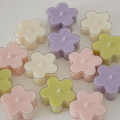 many small candles are arranged in the shape of flowers