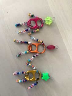 four pairs of colorful beaded eyeglasses are lined up on a table top