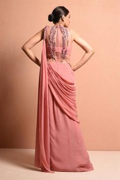 Rose pink draped saree gown with 3D embellished twisted drape shoulder and embellished leaves with 3D resham dori work, pearl, sequin work and glass bead work bodice. Festive Pre-draped Embellished Dresses, Georgette Gala Dress With Traditional Drape, Embellished Pre-draped Saree For Wedding, Embellished Pre-draped Evening Dress, Elegant Side Open Georgette Dress, Pre-draped Embellished Festive Gown, Embellished Draped Evening Dress, Festive Pre-draped Wedding Gown, Embellished Saree Dress For Gala