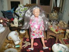 a doll is standing in the middle of a cluttered room