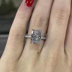 a woman's hand with a diamond ring on it