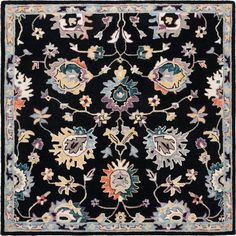 a black rug with colorful flowers and leaves on the bottom, in an ornate pattern