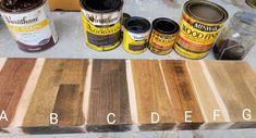 several different types of wood sitting on top of a table next to some paint cans