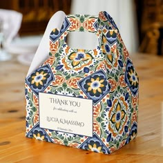 a thank you bag sitting on top of a wooden table