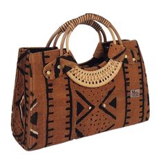 Introducing the Nasika Tote, a stunning handbag crafted from rich mudcloth. This traditional Malian fabric is renowned for its unique texture and cultural significance, making each bag a wearable piece of art. The intricate patterns and earthy tones of the mudcloth create a sophisticated look that's both elegant and eye-catching. With its spacious interior, sturdy cane handles, and inner pocket, this bag is as functional as it is beautiful. Every purchase supports women from low-income weaving c Mud Cloth Bags, Brown Handheld Canvas Bag, Brown Handwoven Bag For Daily Use, Brown Handwoven Top Handle Bag, Handheld Brown Woven Satchel, Handwoven Brown Handheld Bags, Brown Handwoven Handheld Bag, Brown Woven Satchel With Double Handle, Handheld Brown Handwoven Bag