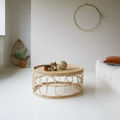 a white room with a wicker coffee table