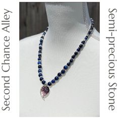 This is one of my handmade, semi-precious stone necklaces that I craft myself. Hi, I'm Ali of Second Chance Alley Designs. This particular necklace is made from 10, 8, and 6mm Dark Blue Tigers Eye semi-precious stone beads. There are Labradorite rondelle semi-precious stone spacer beads as well. There is a lampwork glass pendant in the center that draws your attention. It is spaced with elegant silver beads between each stone bead and is finished with a beautiful toggle style clasp. It measures Blue Natural Stones Necklace For Everyday Wear, Blue Necklaces With Natural Stones For Everyday, Handmade Sapphire Necklaces With Round Beads, Everyday Blue Necklaces With Natural Stones, Lapis Lazuli Crystal Necklace For Jewelry Making, Lapis Lazuli Crystal Necklaces For Jewelry Making, Handmade Sapphire Necklace With Round Beads, Handmade Sapphire Round Bead Necklaces, Sapphire Necklaces With Healing Gemstone Beads