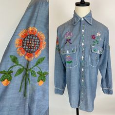 Groovy 1970s hand embroidered BIG MAC denim chambray hippie shirt. Lightweight, super soft cotton blend. Button front. Men's workshirt altered for a womens fit.  SIZE: Modern Women's Small CONDITION: Very good! Light general wear. Some distressing to chain stitch embroidery at shoulder. Bust: 39" Waist: 36" Hips: 38"  Length: 30" Shoulder to shoulder: 16" across Sleeve length: 23" Bohemian Cotton Button-up Shirt, Bohemian Embroidered Button-up Shirt, Bohemian Shirt With Button Closure For Spring, Spring Bohemian Button-up Shirt, Bohemian Spring Shirt With Button Closure, Spring Bohemian Shirt With Button Closure, Bohemian Embroidered Button-up Tops, Bohemian Shirt With Floral Embroidery For Fall, Bohemian Embroidered Shirt For Spring