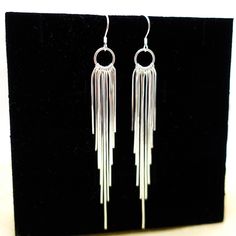 Shinny tassel earrings made by 925 sterling silver , with 11 strings of tassels each, they are just Absolutely Stunning. Perfect for everyday and special occasions . One of my Customers said they are like " flowing silver river"  . For Matching Necklace please go: https://www.etsy.com/listing/1453303841/tassel-necklace-sterling-silver-long?click_key=411a8703bb3458c8fddd241b95e632a9e5ec40cd%3A1453303841&click_sum=4f8f71ce&ref=shop_home_active_1&pro=1&frs=1&sts=1 Return to the home page, click here : https://www.etsy.com/shop/tibicollection Party Sterling Silver Dangle Bridal Earrings, Sterling Silver Dangle Bridal Earrings For Party, Party Bridal Dangle Earrings In Sterling Silver, Sterling Silver Pierced Chandelier Earrings For Party, Dangle Tassel Earrings For Celebration, Sterling Silver Dangle Earrings For Party, Sterling Silver Chandelier Earrings For Party, Evening Dangle Hoop Earrings With Ear Wire, Sterling Silver Dangle Chandelier Earrings For Party