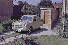 an old car parked in front of a house