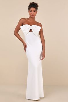 Exceptional elegance just comes naturally with a look like the Lulus Coveted Glamour White Strapless Bow Mermaid Maxi Dress! Stretchy crepe knit shapes this fabulous gown that features a sweetheart neckline (with hidden no-slip strips) and a strapless bodice adorned with a dramatic oversized bow and cute keyhole cutout below it. The high, empire-style waist tops a figure-flaunting, mermaid-style maxi skirt that falls to a sweeping maxi hem. Hidden back zipper/clasp. Fit: This garment fits true t White Formal Dress Long, White Long Dress Formal, Masquerade Formal, White Long Dresses, Prom Dresses Long Elegant, Bow Cutout, White Prom Dress Long, Maxi Dress Strapless, White Evening Gowns