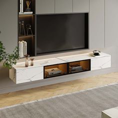 a living room with a large television on top of a wooden entertainment center next to a potted plant