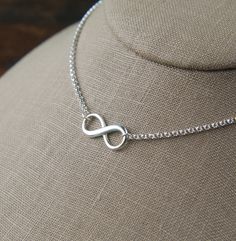 Infinity symbol necklace in sterling silver, sturdy, infinity necklace, silver infinity, eternity necklace, mother's day A sterling silver infinity symbol with raised edges measures 0.37 x 0.75 inches (9.5 x 19mm) and is attached to a sterling silver rolo chain that can be any length up to 22 inches. It is secured with a sterling silver lobster claw clasp. Your purchase will arrive in a jewelry box ready for gift giving or as a gift for yourself! Enter my shop here: jersey608jewelry.etsy.com Tha Silver Infinity Dainty Necklace, Silver Infinity Necklace In Dainty Style, Sterling Silver Infinity Necklace With Adjustable Chain, Silver Dainty Infinity Necklace, Silver Infinity Jewelry, Dainty Silver Infinity Necklace, Infinity Cable Chain Jewelry Gift, Adjustable Sterling Silver Infinity Necklace, Hypoallergenic Sterling Silver Infinity Jewelry