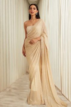 Beige ombre georgette saree with sequins embroidery. Comes with a padded blouse having cutdana embroidery and a petticoat.
Component: 3
Pattern: Embroidered
Type Of Work: Sequins, Cutdana
Sleeve Type: Sleeveless
Fabric: Georgette
Color: Beige
Other Details: 
Cutdana work on blouse
Occasion: Wedding - Aza Fashions Saree Cape, Sawan Gandhi, Shaadi Outfits, Lehenga Latest, Sequins Saree, Mirror Work Saree, Cape Set, Desi Outfits, Sequin Saree