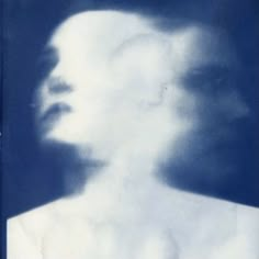 a man's face is shown in the middle of a blue and white photo