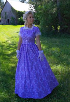 This classic Frontier dress is as flattering as it is accommodating. It is perfect for attending any prairie or western daytime event or for long days working on the homestead. The square neckline frames the face with lovely lace trim. Comfortable short sleeves add comfort and are finished off with the same lace. You will love the look of the button-down bodice. The long skirt that follows will look stunning blowing in the wind during your prairie adventure. Hand or machine wash cold gently; tum Laura Ashley Prairie Dress, Fitted Prairie Dress With Square Neck For Daywear, Fitted Cotton Prairie Dress, Fitted Short Sleeve Prairie Dress For Daywear, Fitted Short Sleeve Victorian Dress For Summer, Fitted Prairie Dress In Pastoral Style, Fitted Prairie Dress With Square Neck For Garden Party, Fitted Prairie Style Summer Dress, Cotton Prairie Dress With Short Sleeves