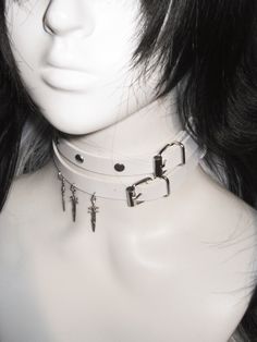 This double-wrap choker is a statement piece that adds an edgy flair to any outfit. The choker features stud embellishments and a distinctive sword pendant, creating a bold and unique look.  Please note that the price includes one choker only. Adjustable Emo Choker For Alternative Fashion, Edgy Choker For Alternative Fashion, Adjustable Emo Choker For Concerts, Emo Alternative Fashion Choker, Adjustable Punk Choker For Cosplay, Adjustable Punk Style Choker For Cosplay, Trendy Metal Jewelry For Cosplay, Rocker Style Festival Choker Jewelry, Edgy Adjustable Choker For Festival